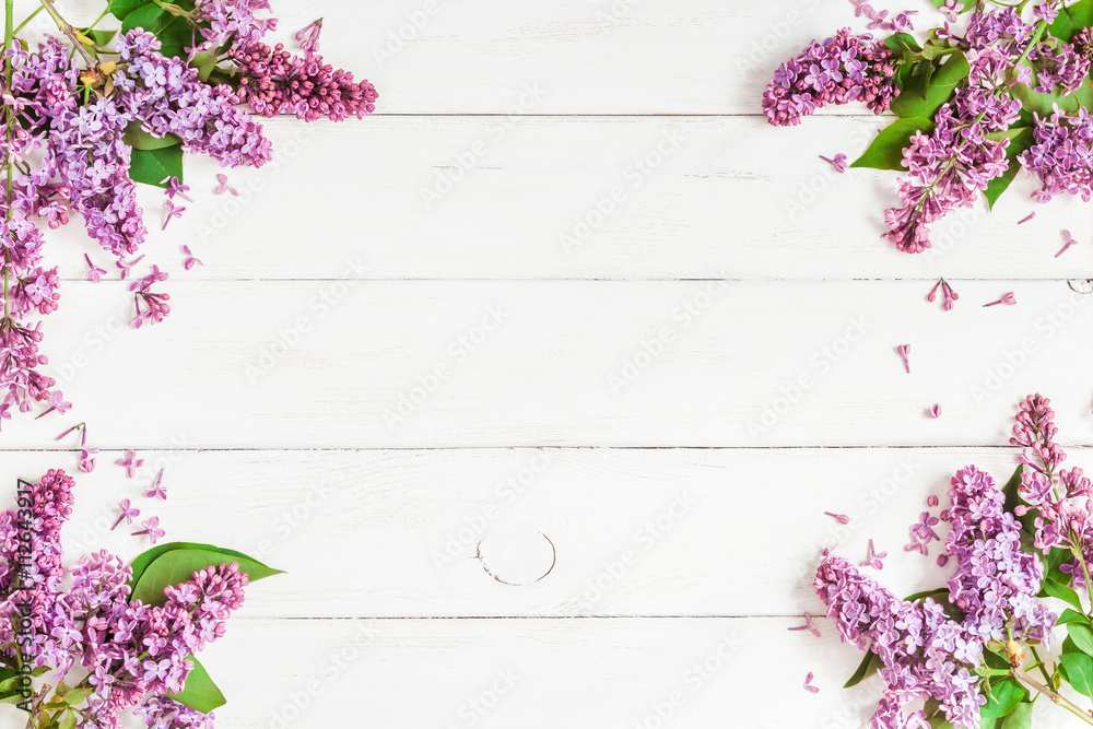 lilac flowers on white wooden background, top view, flat lay
