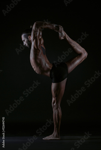 man practicing yoga, studio photo © vakidzasi