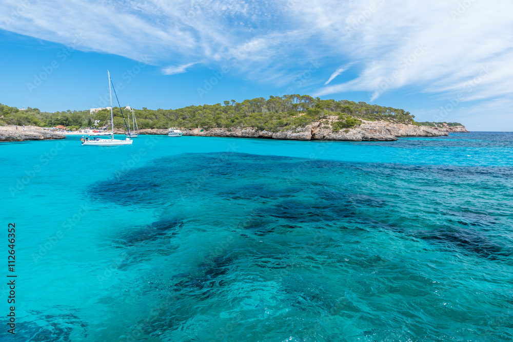 Sailing boats at Cala Mondrago - beautiful beach and coast of Mallorca