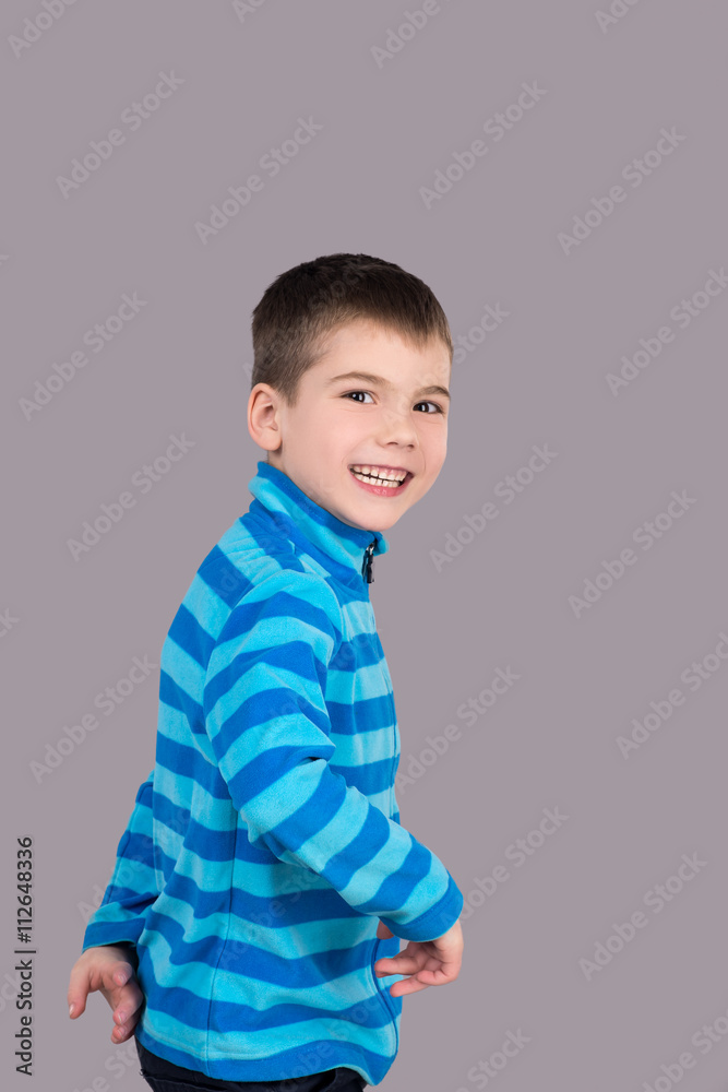 teenager child boy laughing and looking at the camera on a gray background, isolated. feelings and emotions, admiration and pleasure teenager child boy laughing and looking at the camera on a gray background, isolated. feelings and emotions, admiration and pleasure