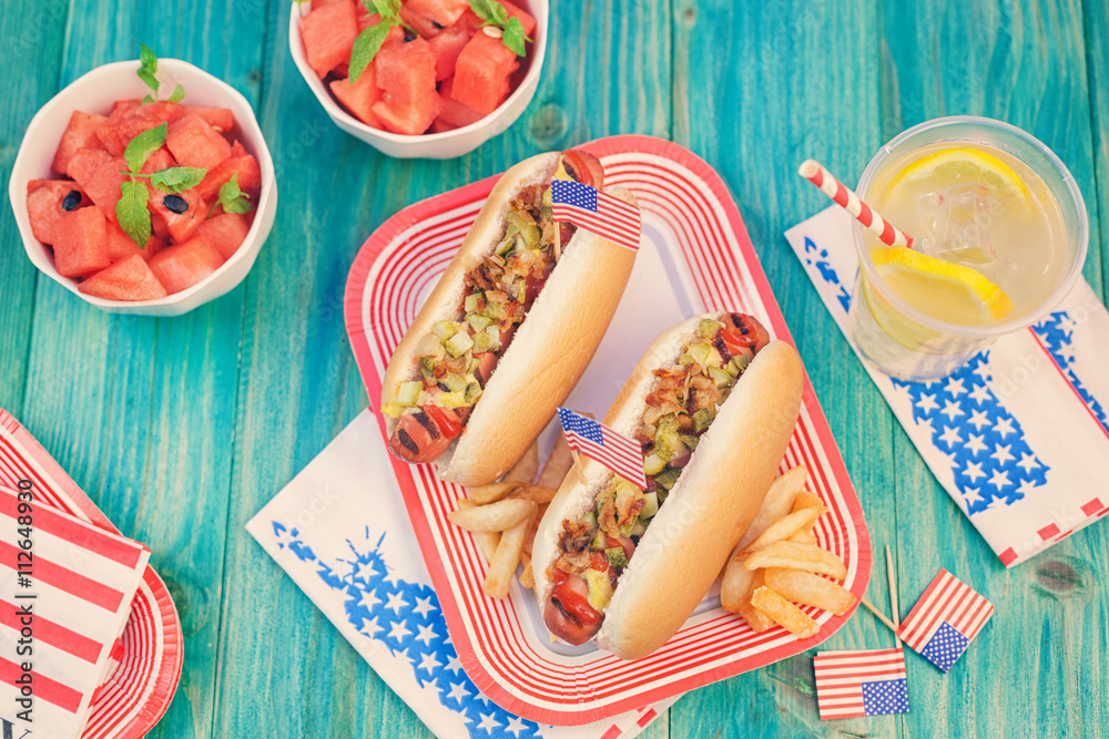 Foto de American hot dog with pickles, fried onions, ketchup, mustard and Lemonade at a Picnic