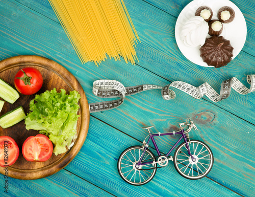 Choice of food: diet, vegetables and sports or cake, candy 