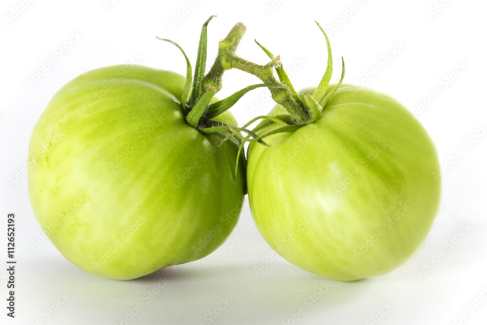 Fresh homegrown green tomatoes on white background. Fresh homegrown green tomatoes on white background.