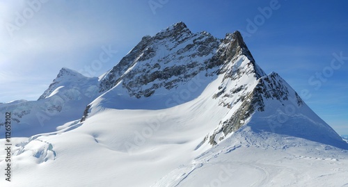 Jungfrau Mount winter view with blue sky at background. View from Jungfraujoch  Jungfrau region  Switzerland.