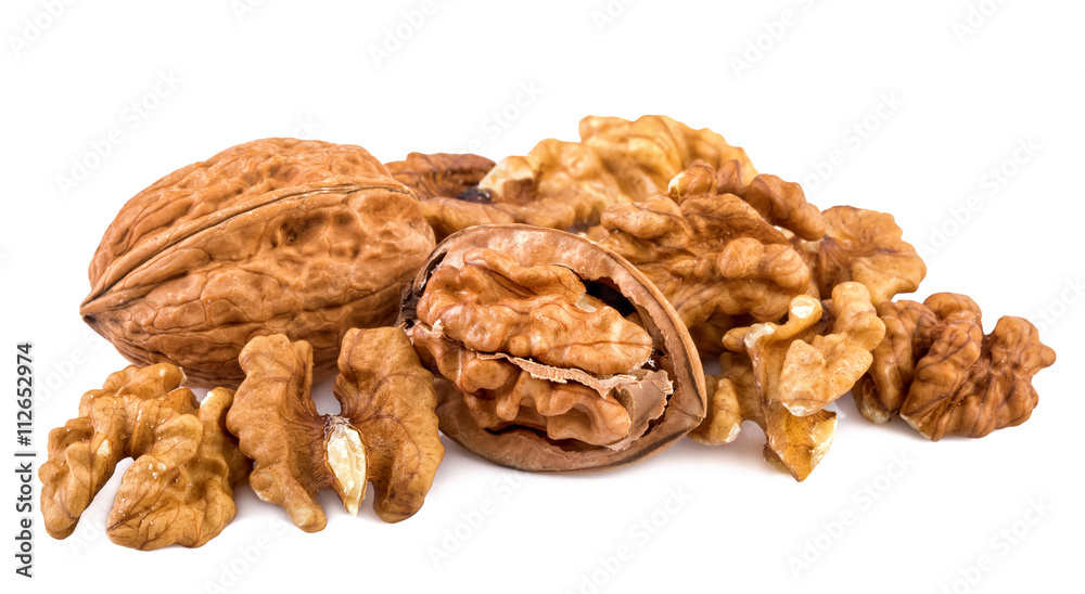 Walnuts and shelled walnuts on white background. Closeup. Walnuts and shelled walnuts on white background. Closeup.