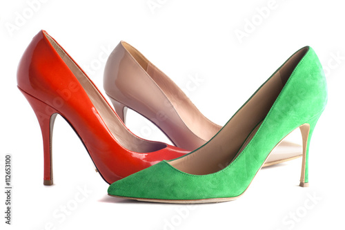 bright, multicolored female shoes on high heels isolated on white background