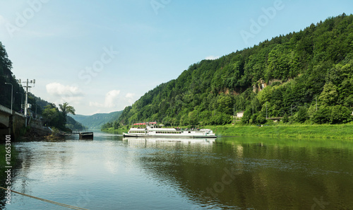 Cruise ship on the Elbe river through the valley of the Elbe in Saxony