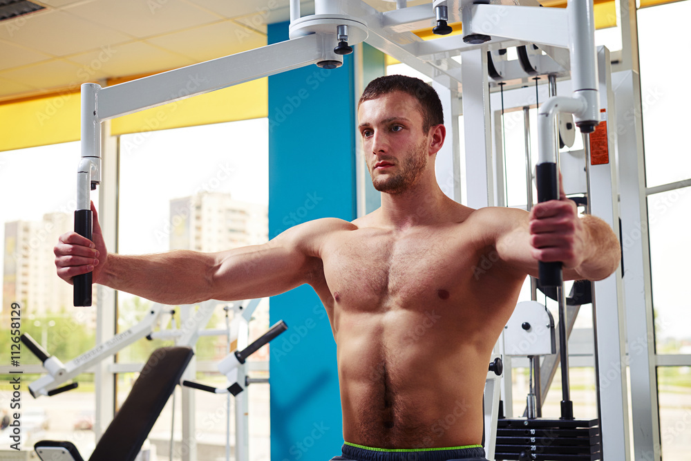 Man is working out chest muscles on the machine Man is working out chest muscles on the machine