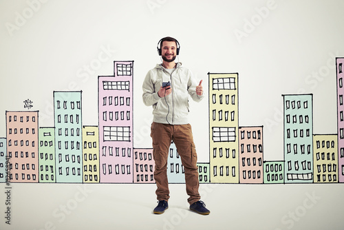 Man showing thumb up gesture on white background with drawn buil photo