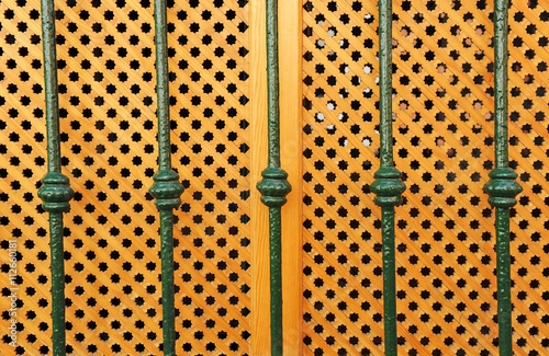 Ventana española con celosía de madera y reja photo