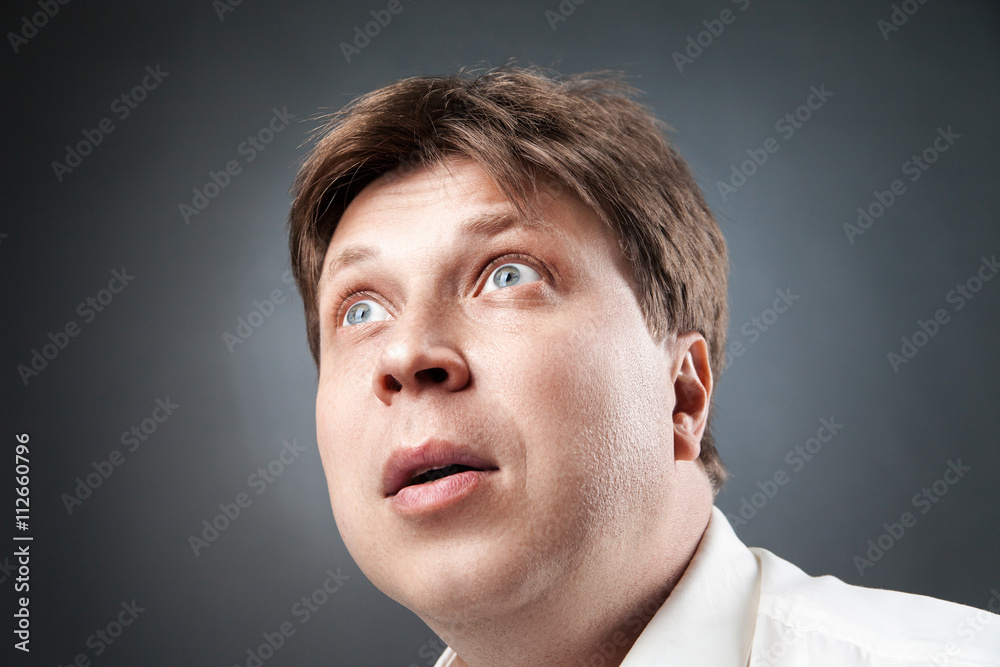 Fototapeta premium Close-up of adult man looking up in amazement