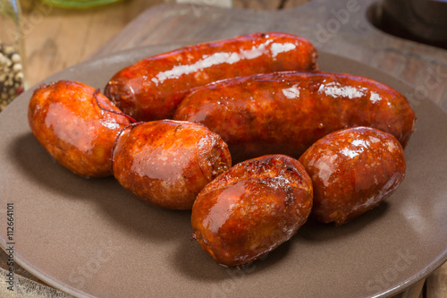 several Iberian sausages grilled in  dish