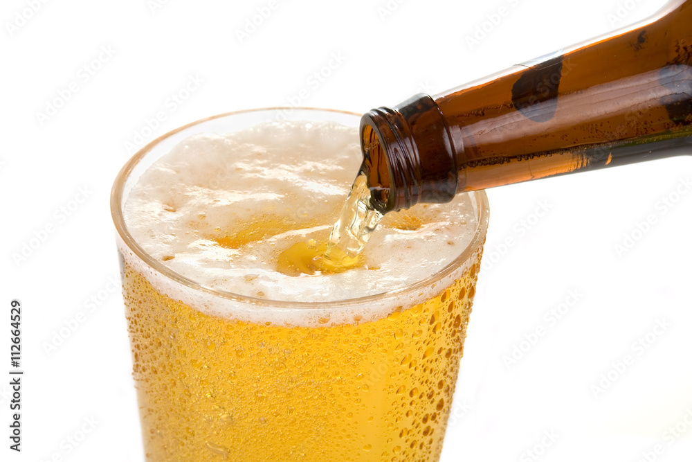Pouring an Ice Cold Beer Beer pours into a cold glass from a beer