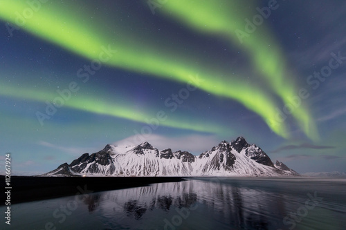 The aurora borealis and the Vestrahorn on a bright, moonlit night, eastern Iceland.