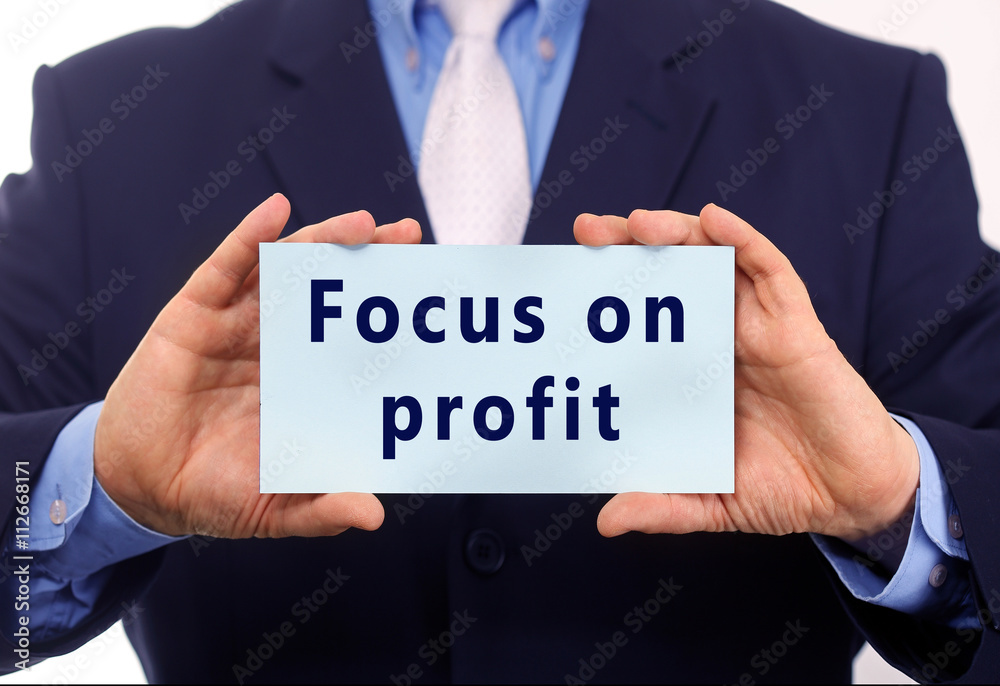 Business man hold paper focus on profit text on it Business man hold paper focus on profit text on it