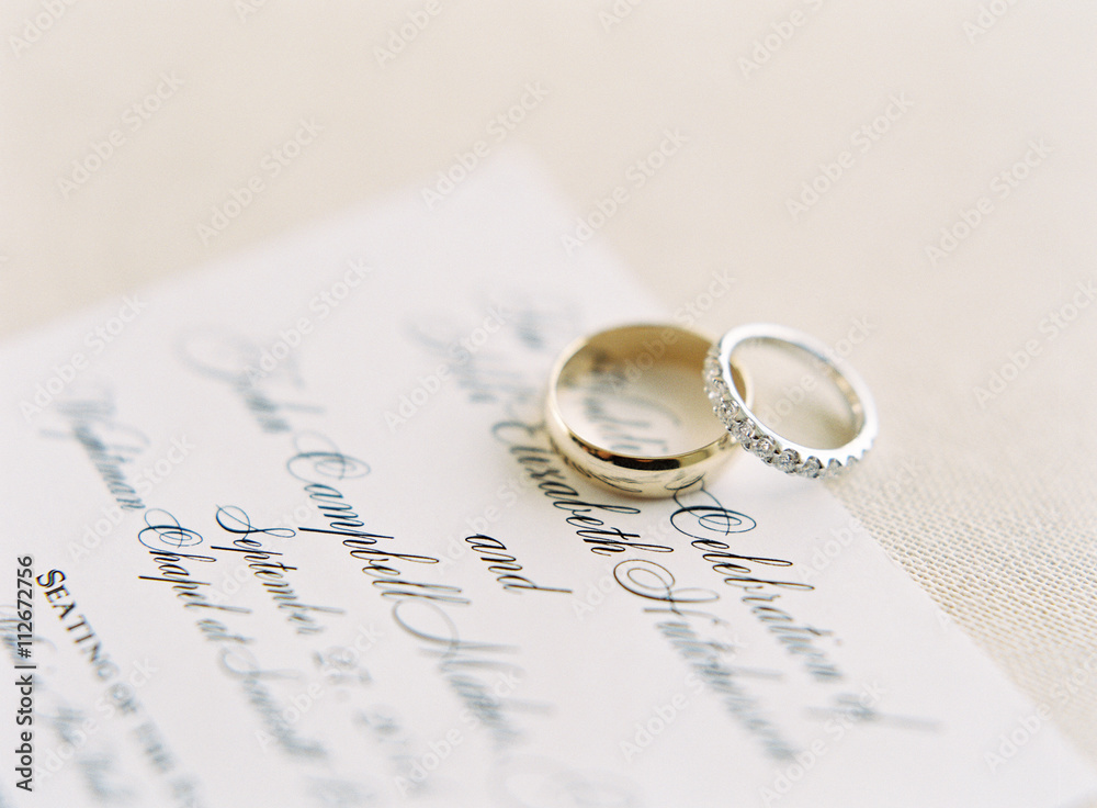 Wedding rings on wedding invitation Stock Photo | Adobe Stock