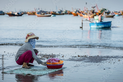 Woman sitting on the beach Mui Ne beach, Vietnam photo