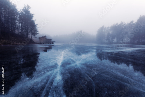 Cabin by frozen lake photo