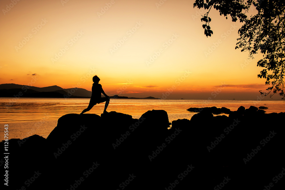 Women exercise and relax on beach sunset background