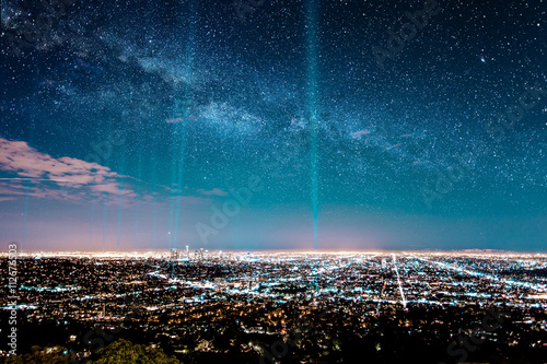 Beans of light in starry sky over los angeles photo