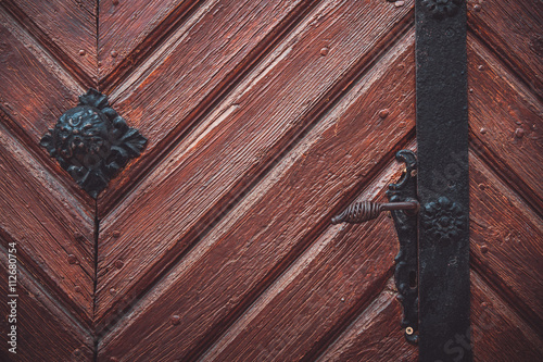 Part decorative old wooden door with textured pattern.