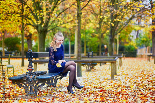 Beautiful young woman in the Luxembourg garden of Paris on a fall day