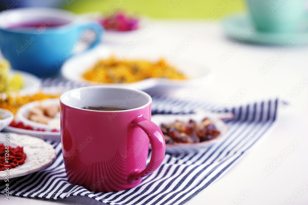 Cup of tea with aromatic dry tea on wooden background Cup of tea with aromatic dry tea on wooden background