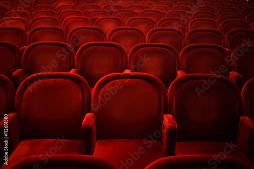 Rows of empty red seats in cinema or theater photo