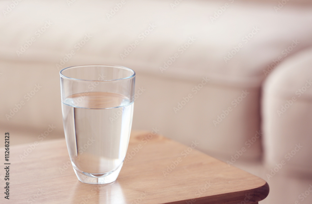 Glass of pure water on wooden table Glass of pure water on wooden table