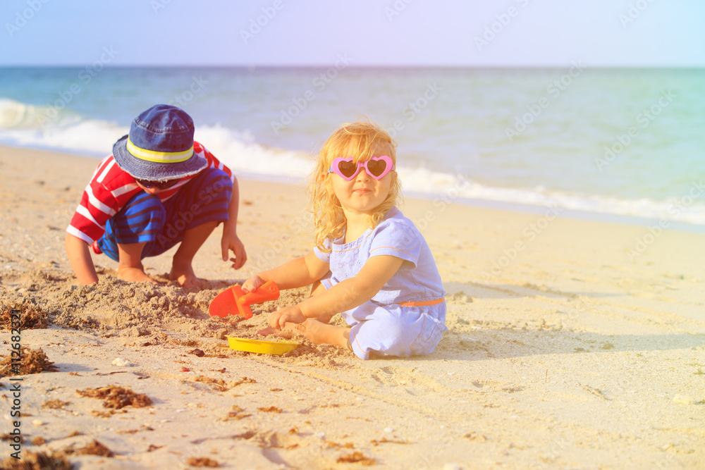kids play with sand on summer beach kids play with sand on summer beach