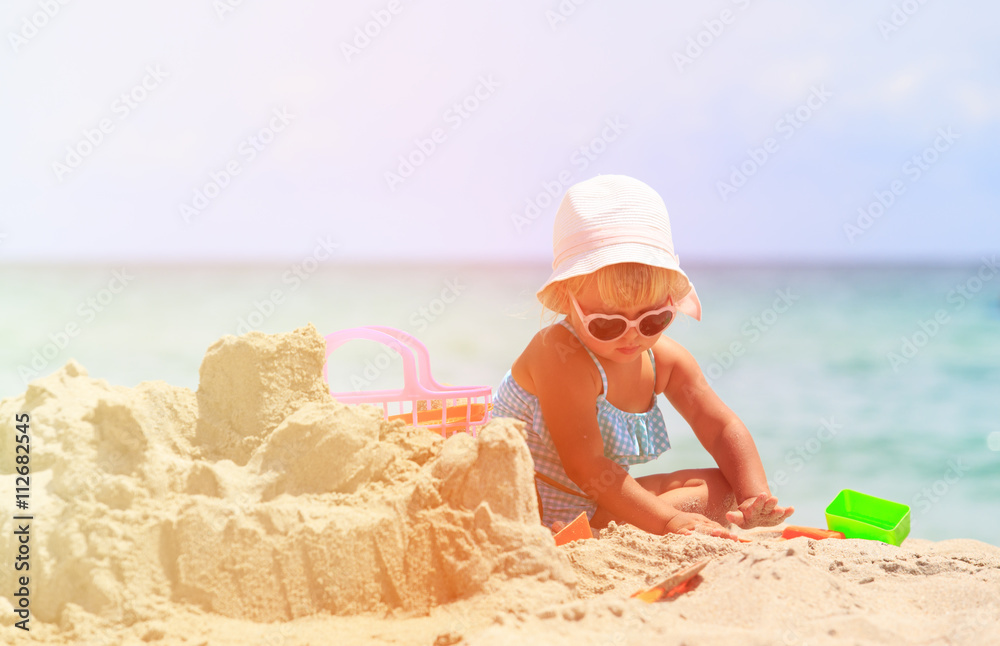 cute little girl play with sand on beach cute little girl play with sand on beach