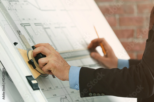 Engineer working with bluep...