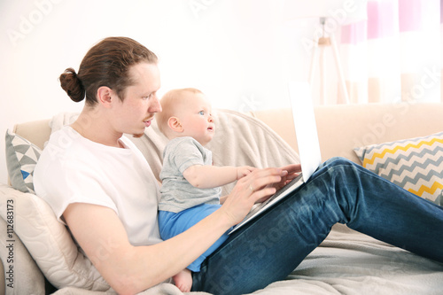 Young father with his littl...