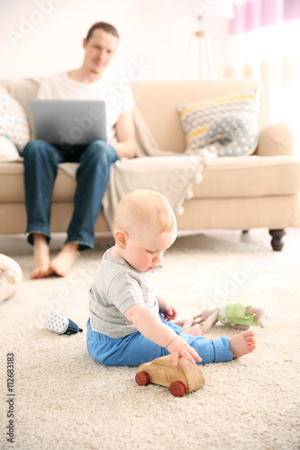 Young father with his littl...