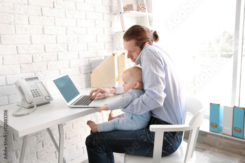 Young father with his little son working at home © Africa Studio