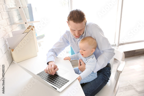 Young father with his littl...