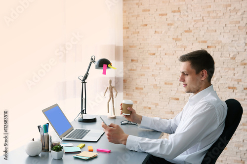 Man working at computer at ...