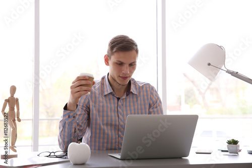 Man working at computer at ...