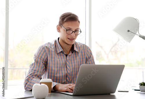 Man working at computer at ...