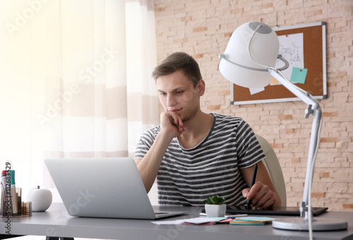 Man working at computer at ...