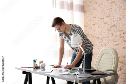 Man working with drawings a...