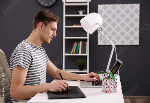 Man working at computer at ...