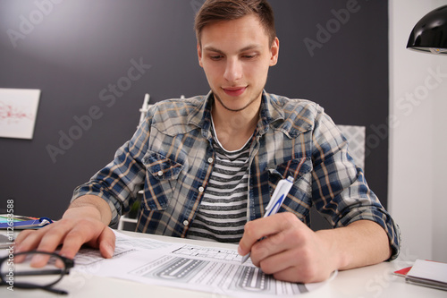 Man working with drawings a...