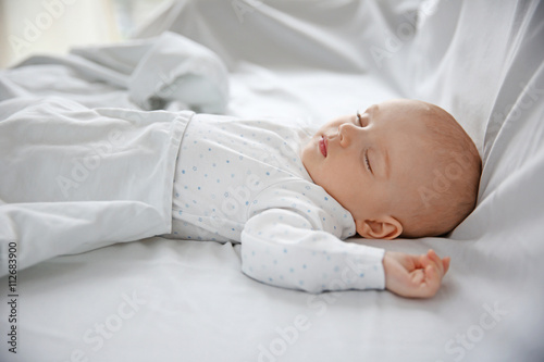 Beautiful sleeping baby in bed