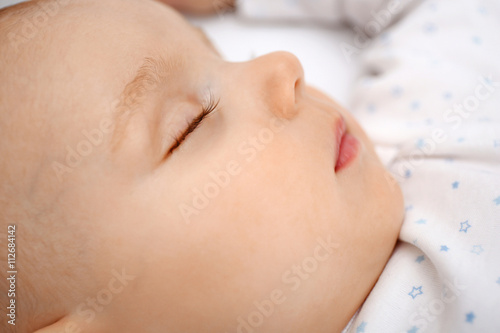 Beautiful sleeping baby in bed