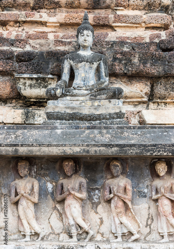 Old stone carvings of the Buddha image and monks