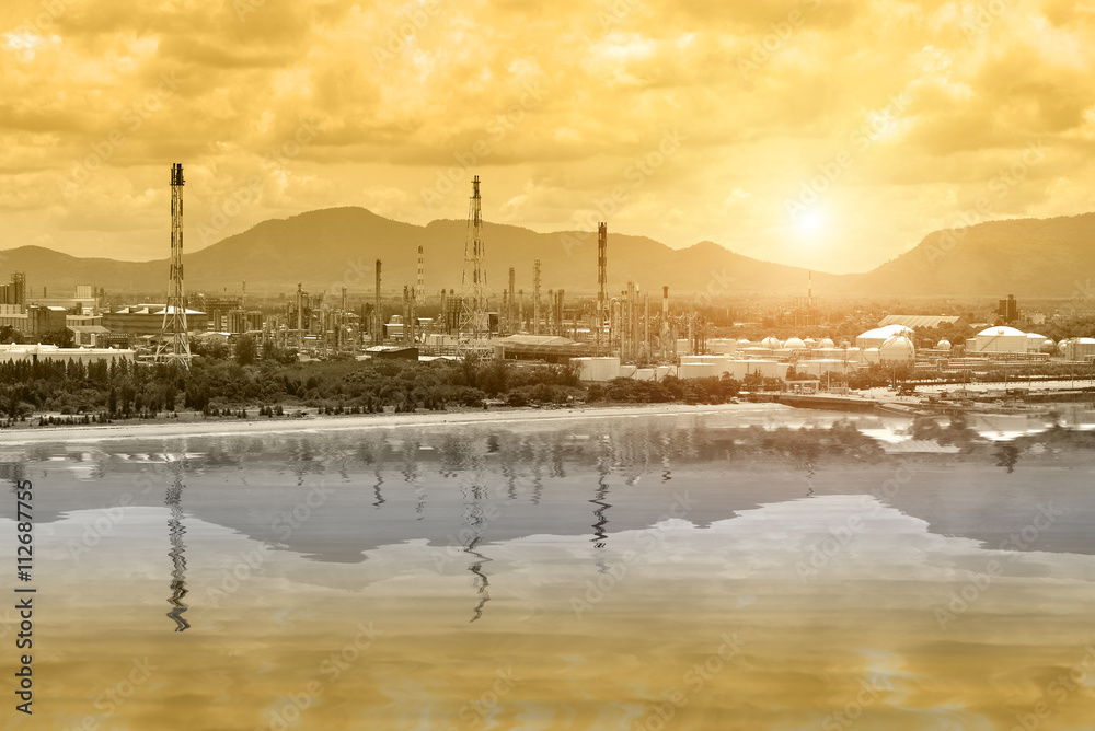 Power plant ,Oil refinery plant of petroleum or petrochemical industry production at sunset and reflection.