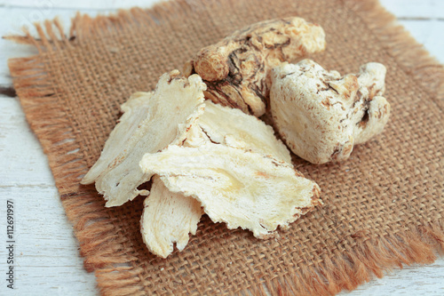 dang gui, angelica sinensis, dang gui ginseng on wooden background, traditional chinese herbal medicine.