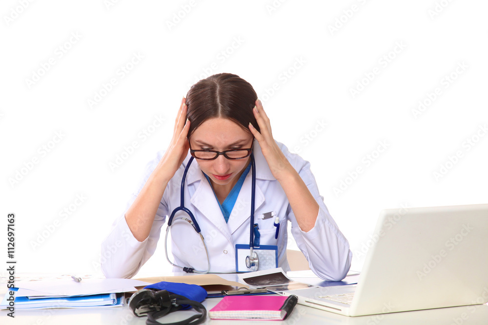 Beautiful general practitioner is working with joy. She is standing with a folder of documents in her hand Beautiful general practitioner is working with joy. She is standing with a folder of documents in her hand