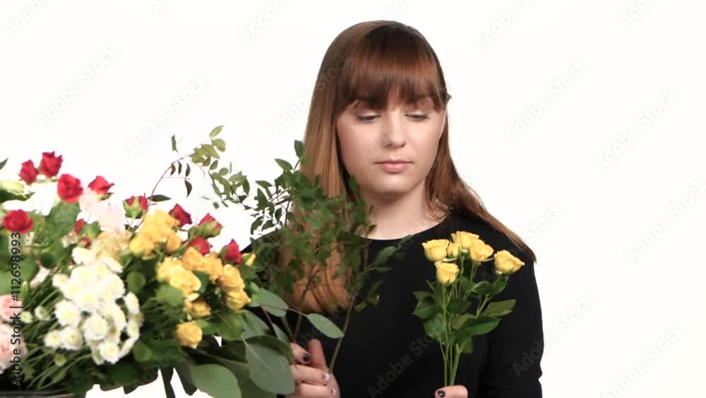 Girl picking flowers in a bouquet. White. Close up Girl picking flowers in a bouquet. White. Close up